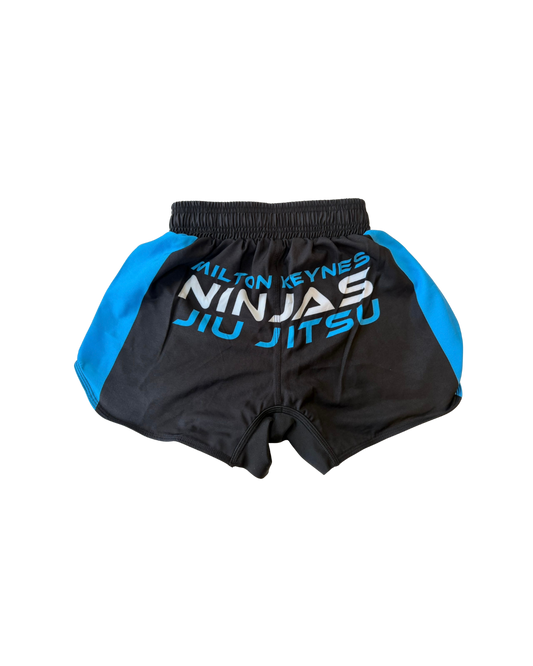 Black and blue martial arts shorts with 'Milton Keynes Ninjas Jiu Jitsu' text