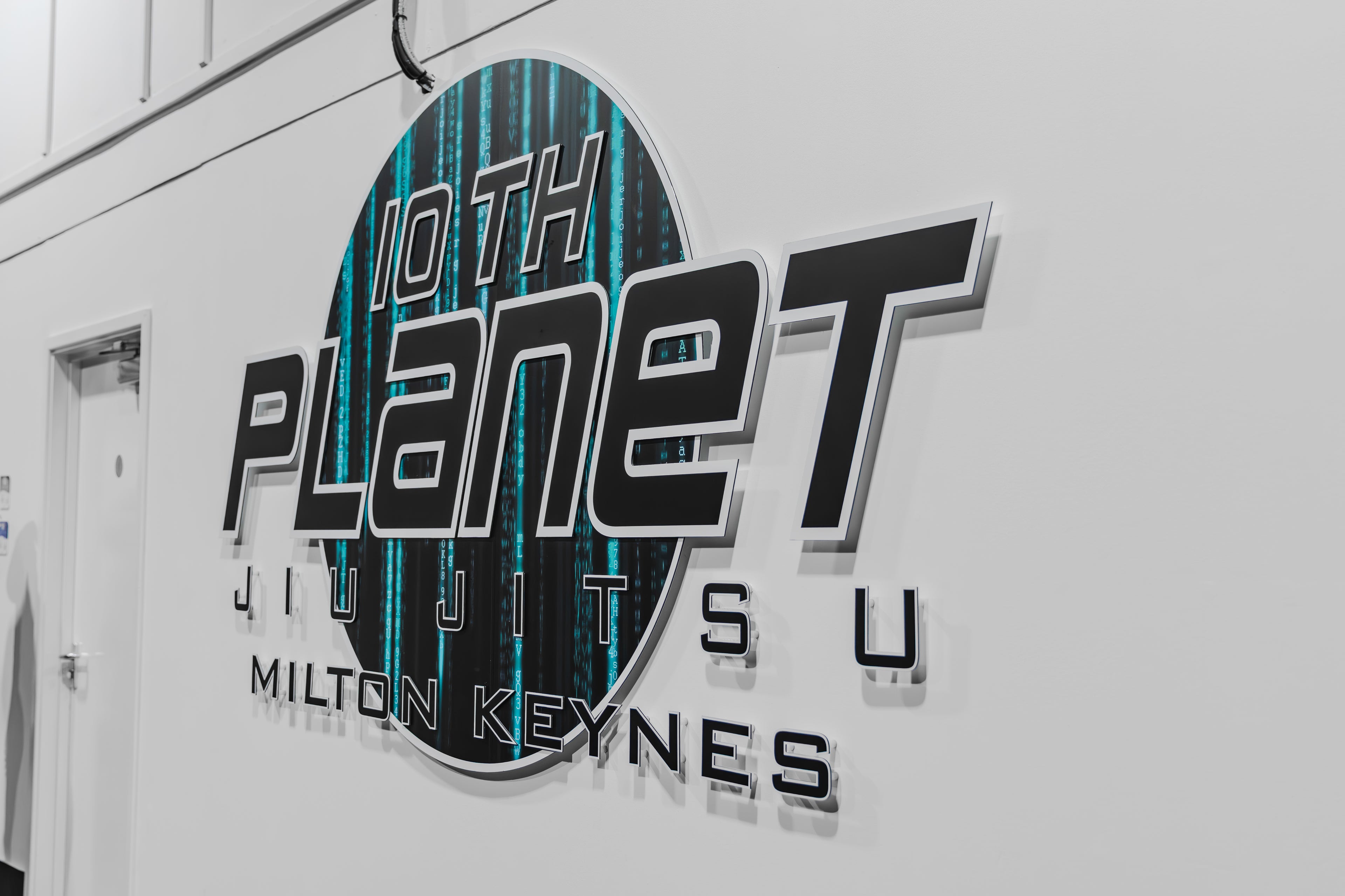 10th planet milton keynes sign on a white wall.