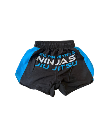 Black and blue martial arts shorts with 'Milton Keynes Ninjas Jiu Jitsu' text